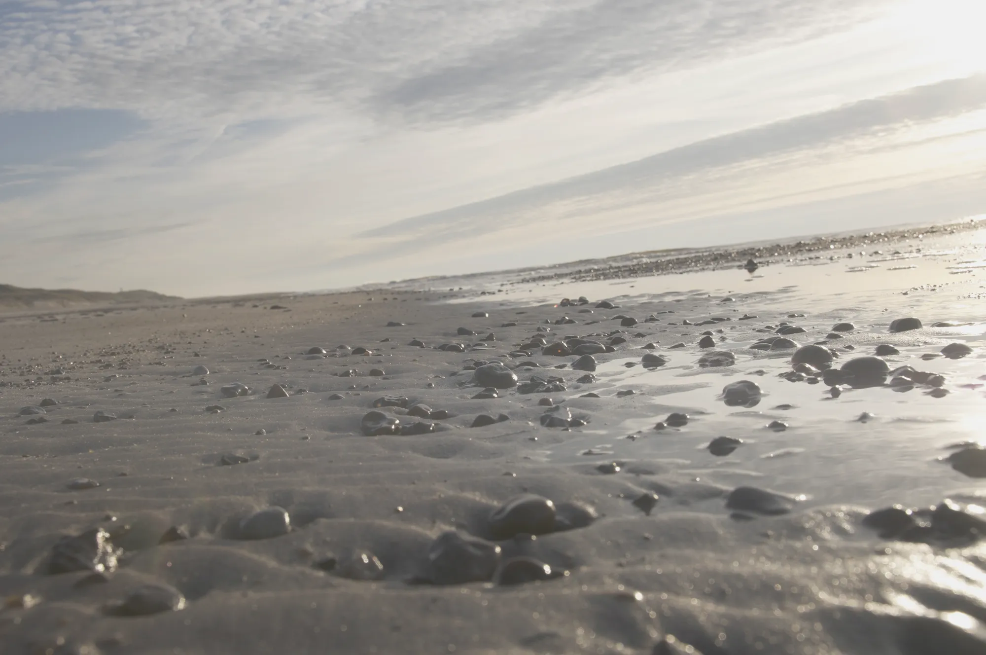 Blasser Himmel über einem diesigen Strand